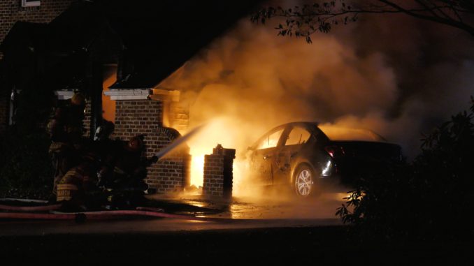 Car burning in house